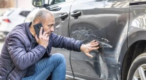 Man on the phone with insurance company after a car accident