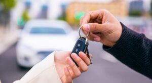 friend handing over keys to another car covered by insurance