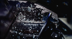 Interior of a car covered by car theft insurance having its window smashed with a crowbar.