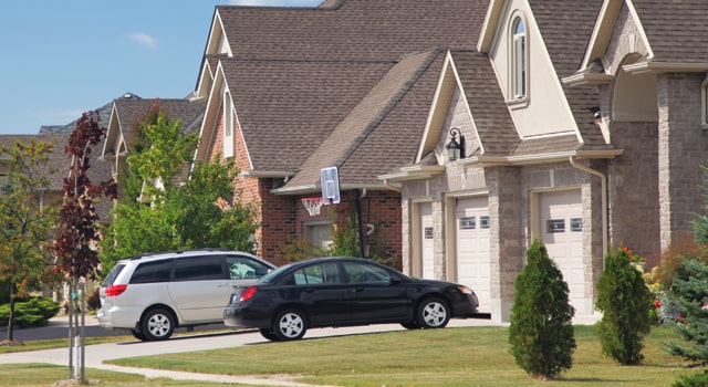 Multiple cars parked in front of house