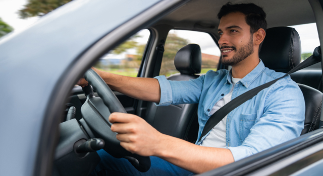 Happy man driving a car.