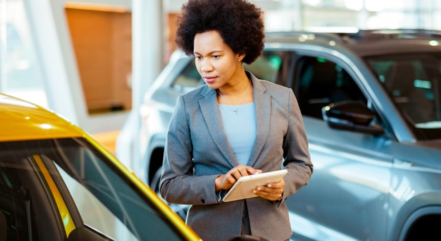 Car insurance adjuster calculating value of a car