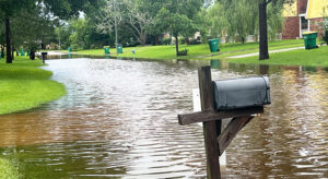 A residential street is flooded with water